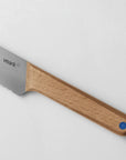 A close up of the birch handle of a Veark bread knife.