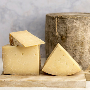 Cuts of various sizes of Bonnington Linn cheese on a wooden board.