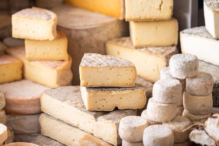 A selection of various cuts and whole pieces of soft cheeses
