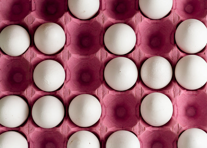 A cardboard tray of white hen's eggs