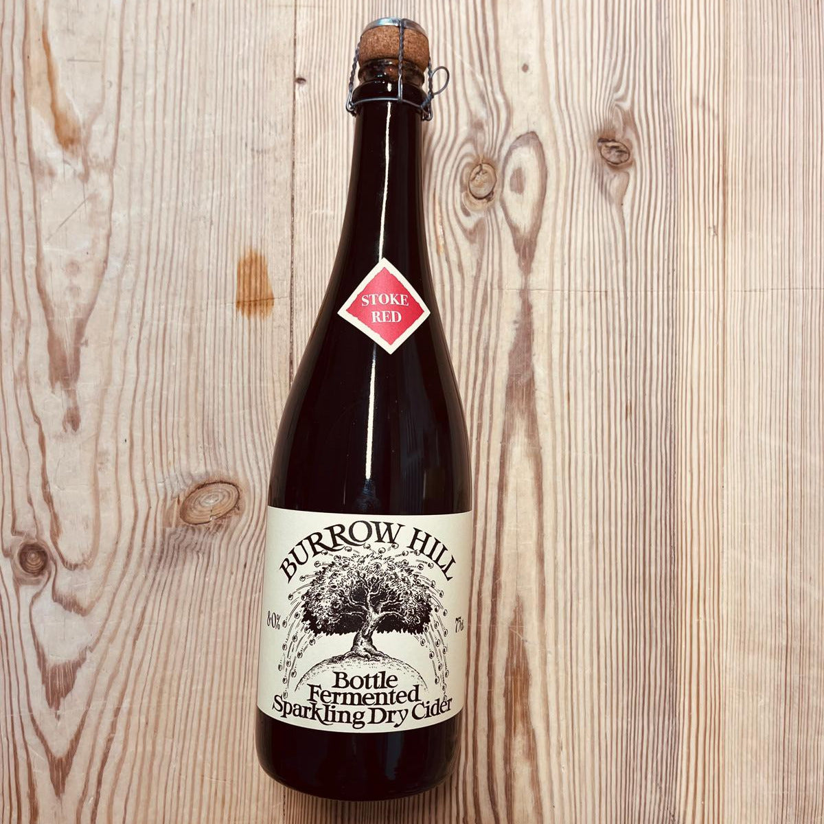 Bottle of Burrow Hill cider on a wooden surface