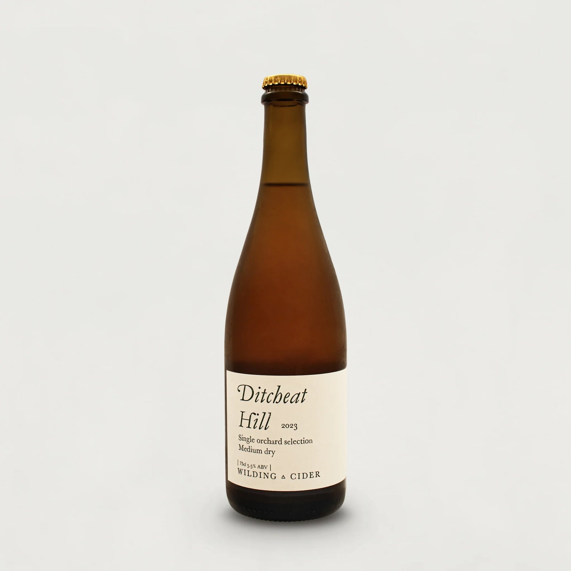 Brown bottle of Ditchbeat Hill cider on a light gray background