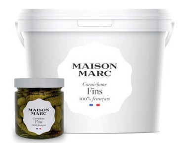 A jar and a large white plastic bucket of Maison Marc cornichons fins.