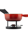 A red cast iron fondue set, complete with forks anf a fuel burner.