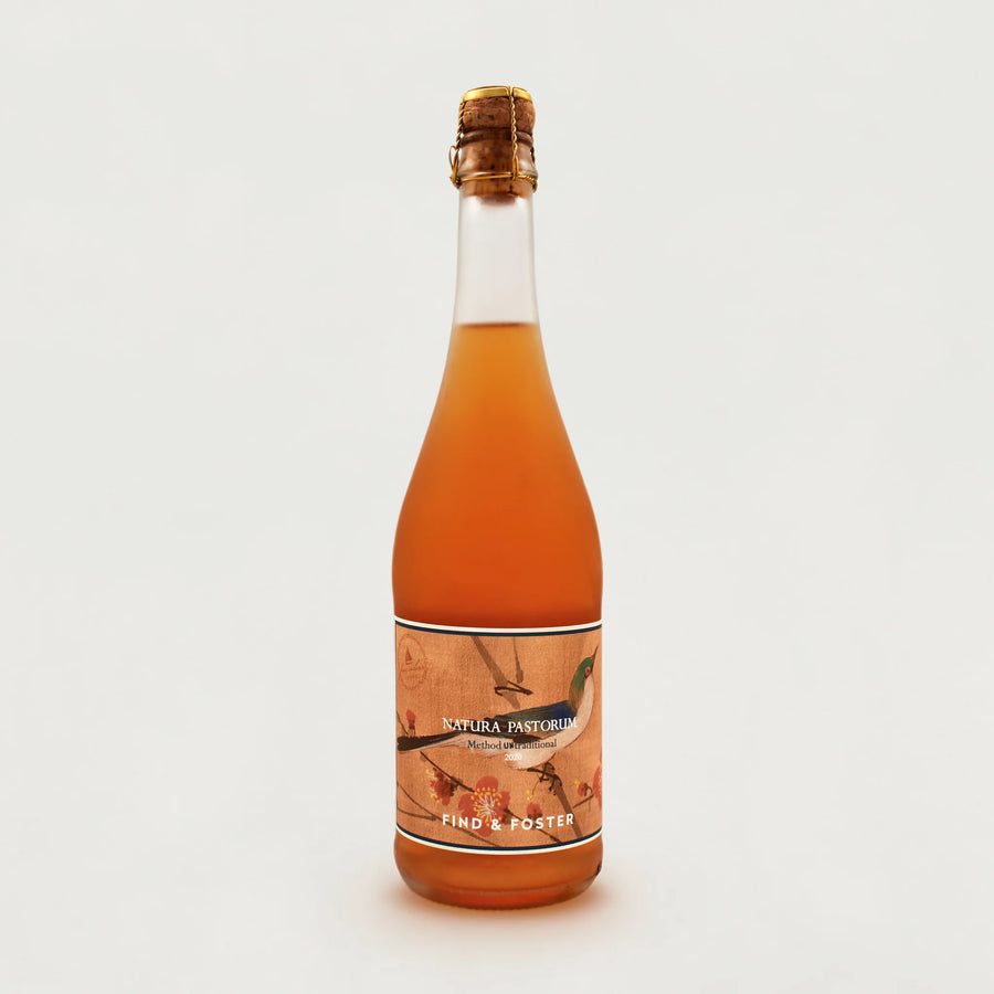 A large glass bottle of Little Pomona cider.