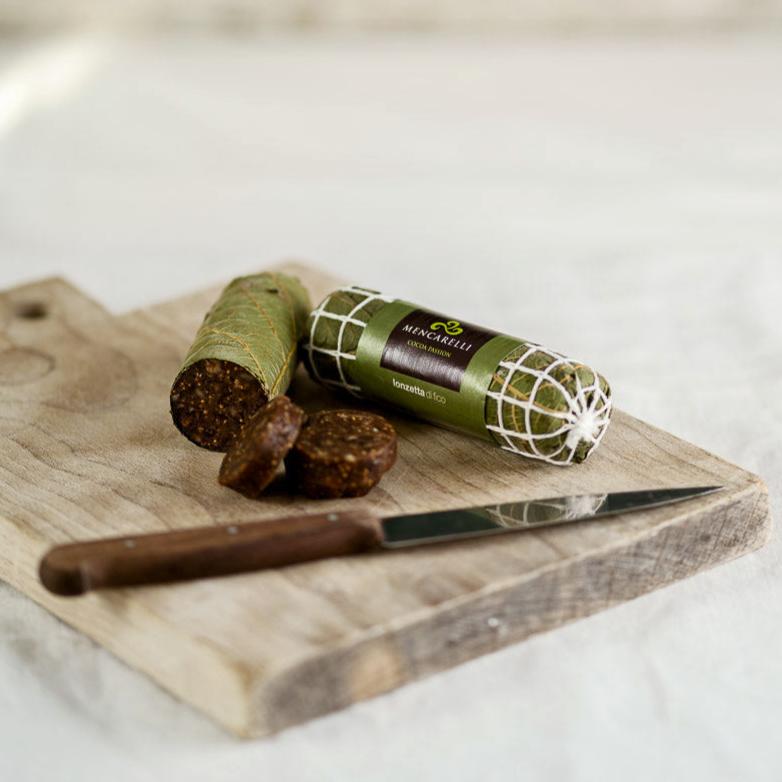Lonzino di Fico fig salami on a wooden chopping board