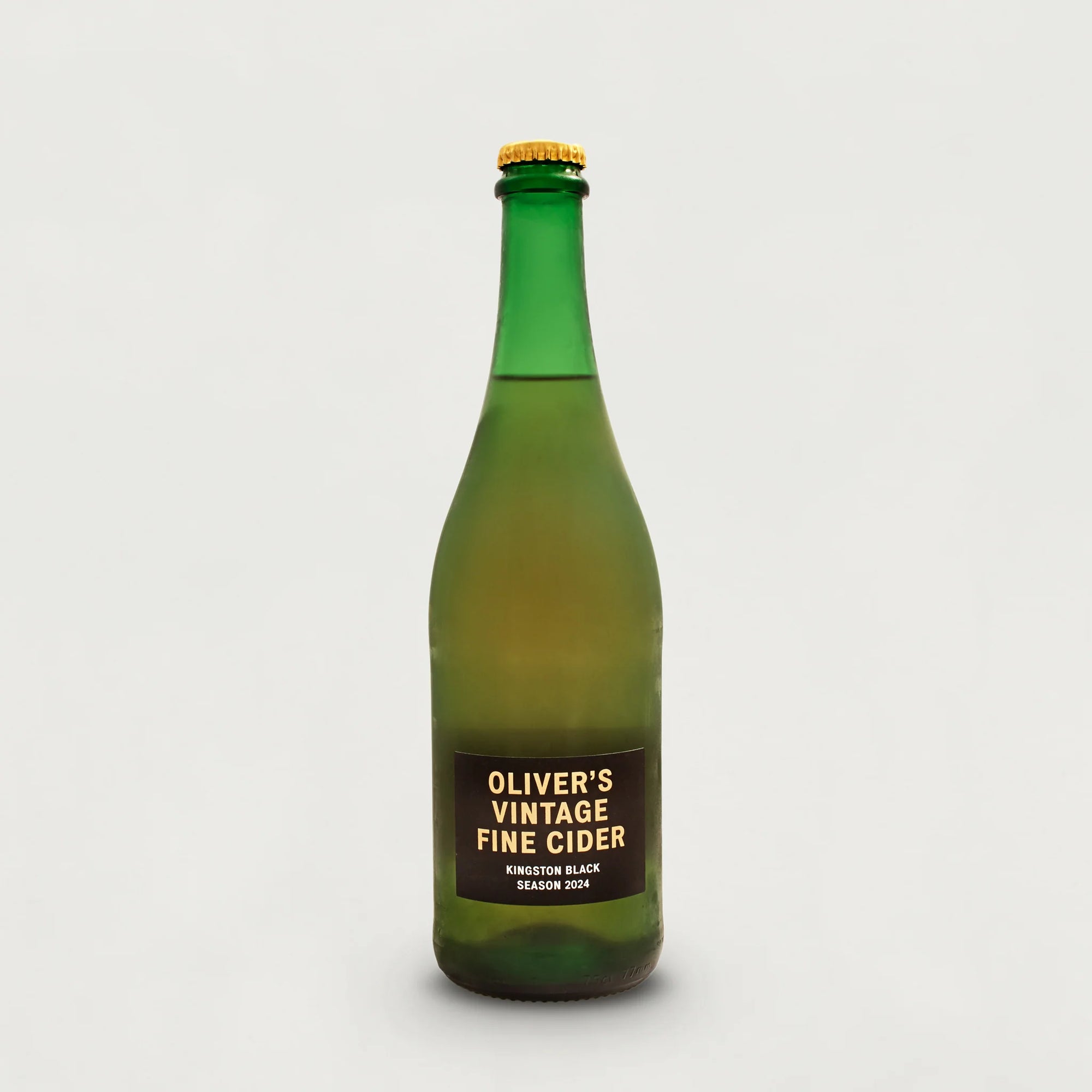 Green bottle of Oliver's Vintage Fine Cider on a white background.