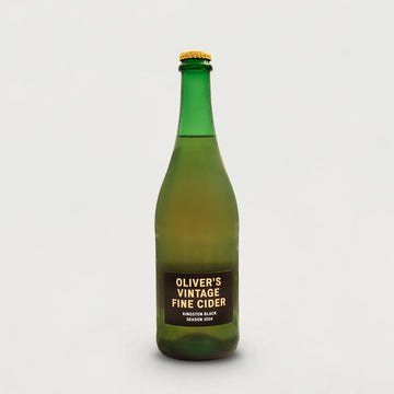 Green bottle of Oliver's Vintage Fine Cider on a white background.