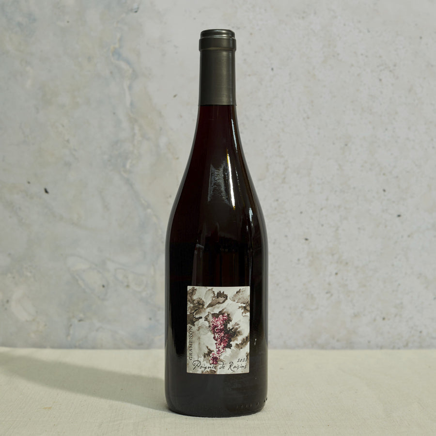 A bottle of Poignee de Raisins cotes du Rhone French red wine.