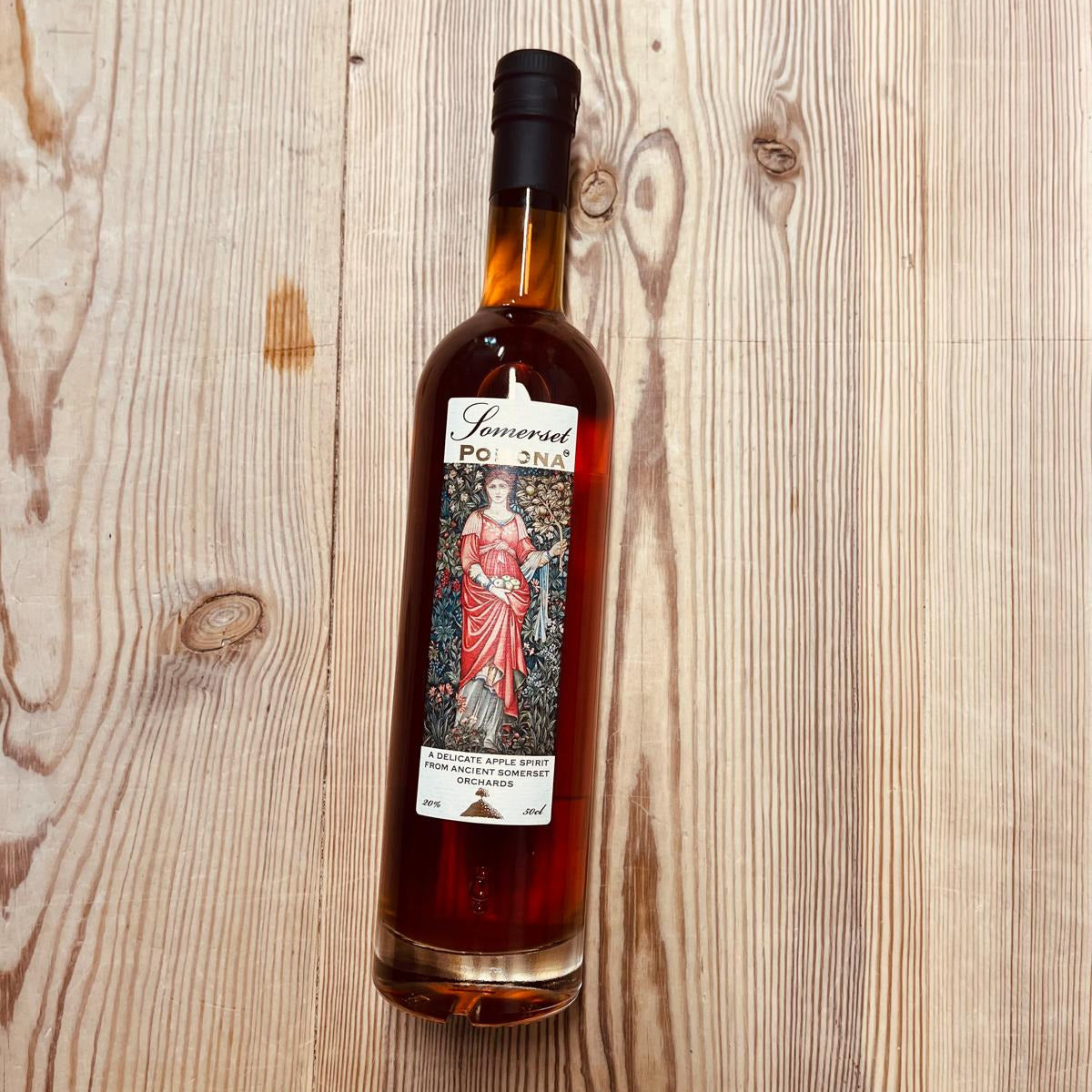 Bottle of liquor with a label on a wooden surface