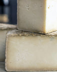 The cut faces of a Tinto hard goat's milk cheese.