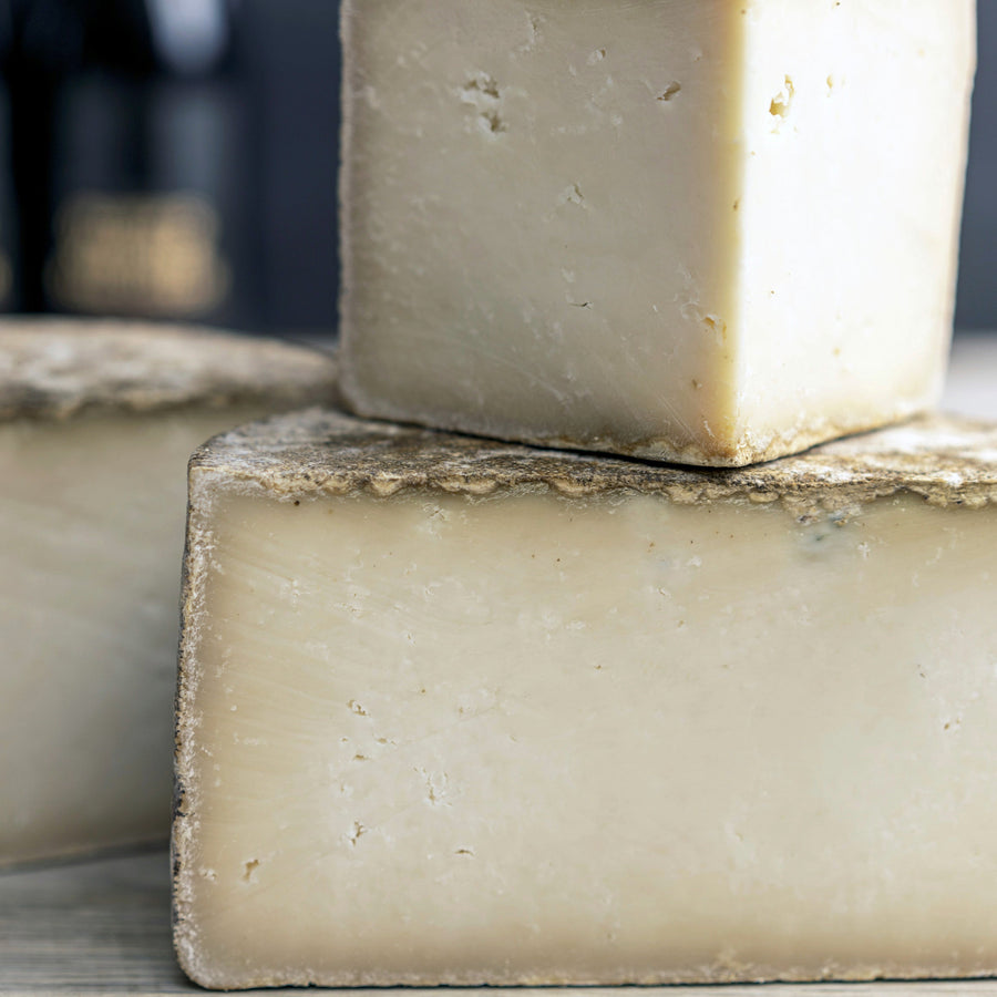 The cut faces of a Tinto hard goat's milk cheese.