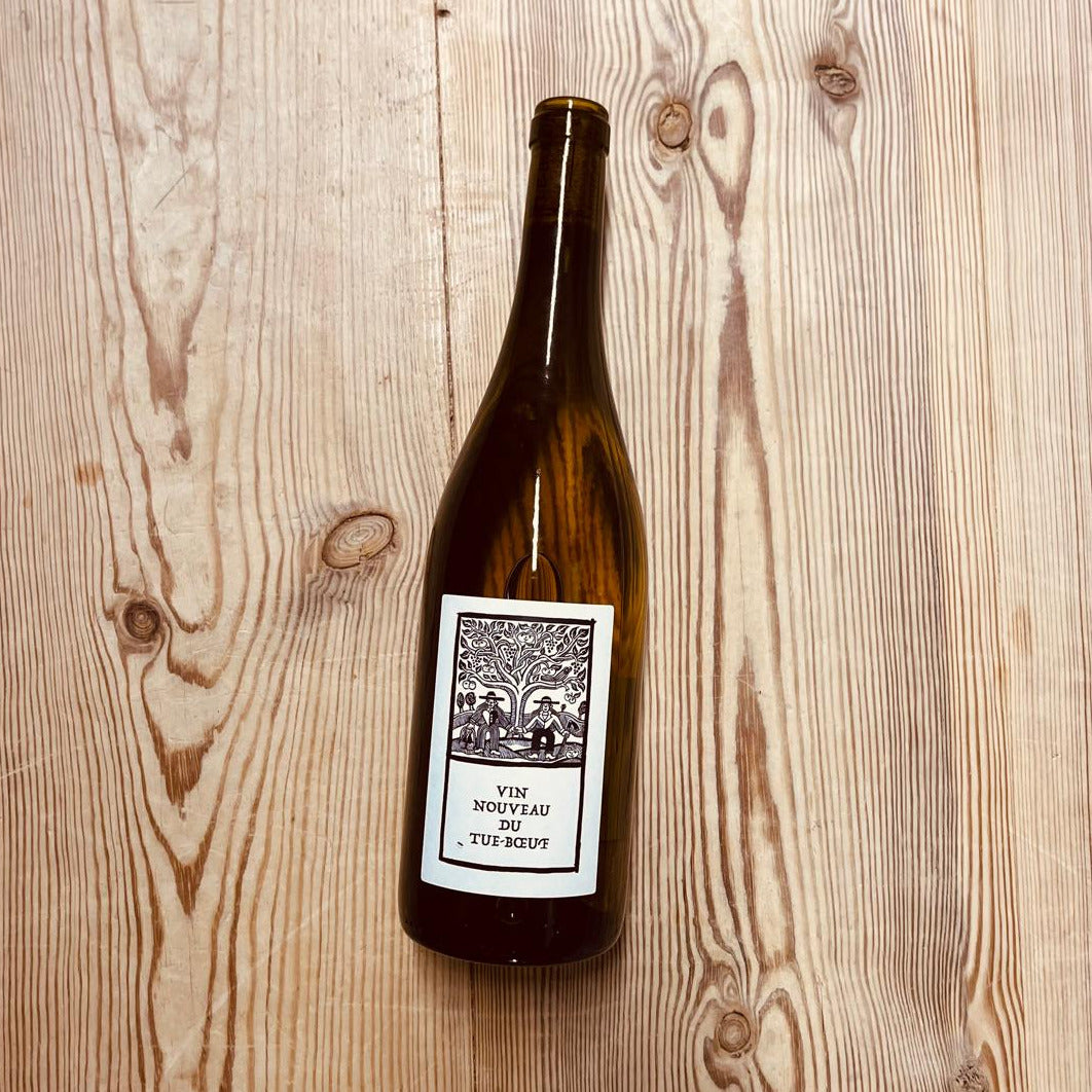 Wine bottle with a label on a wooden surface