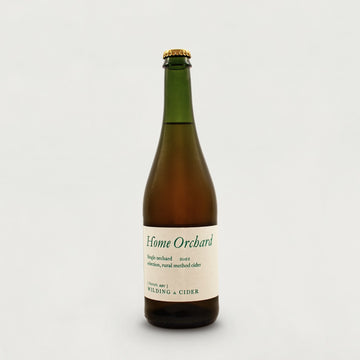 A large green glass bottle of Wilding Home Orchard cider.