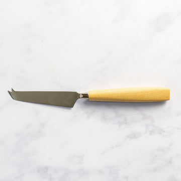 A wooden handled cheese knife on a marble worktop.