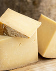 Pieces of Bonnington Linn cheese on a wooden board.