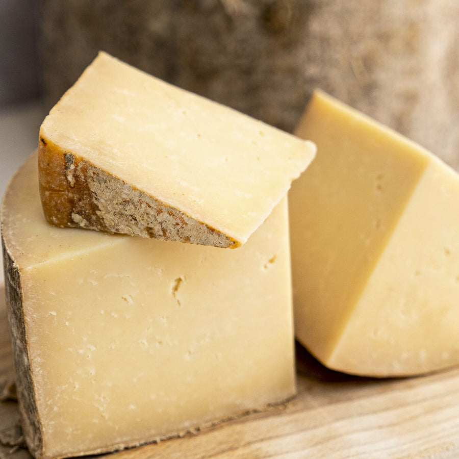 Pieces of Bonnington Linn cheese on a wooden board.