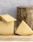 Cuts of various sizes of Bonnington Linn cheese on a wooden board.