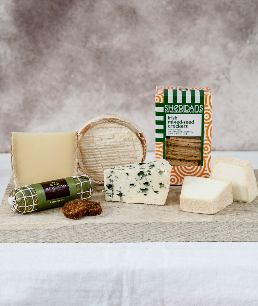 A selection of cuts of cheeses, biscuits and accompaniments