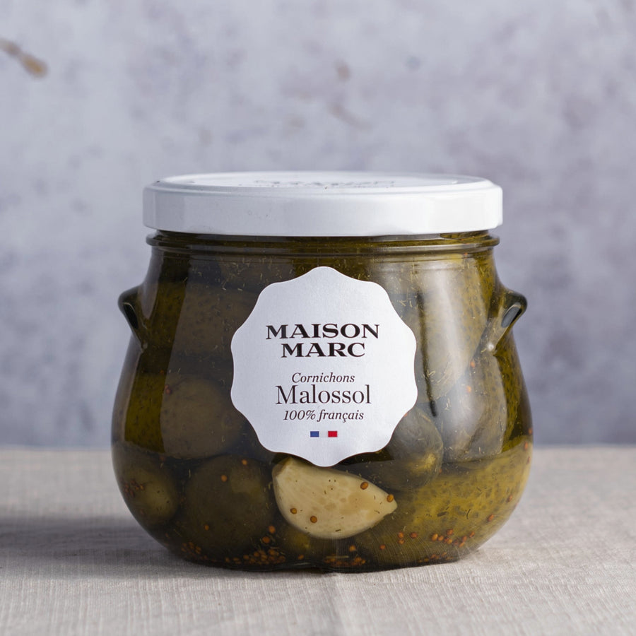 A glass jar of Maison Marc Malossol gherkins.