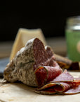 Slices of 'Jesus' salami on a wooden board.