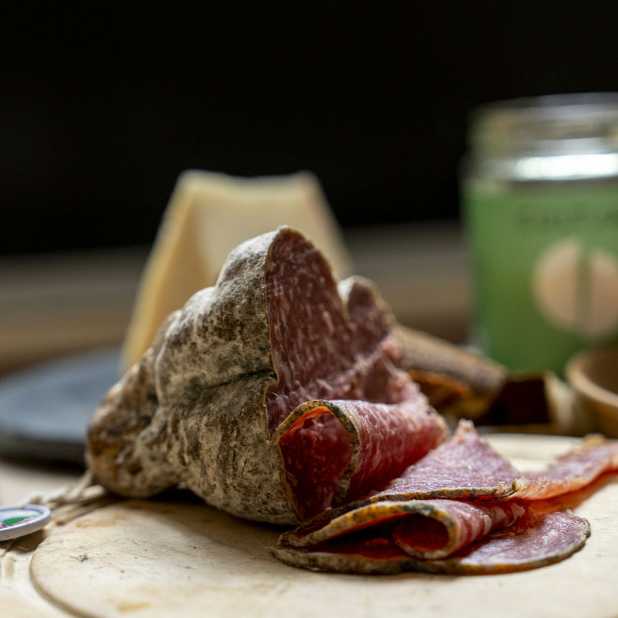 Slices of 'Jesus' salami on a wooden board.