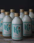 Lots of small glass bottles of 'Ki' kefir.