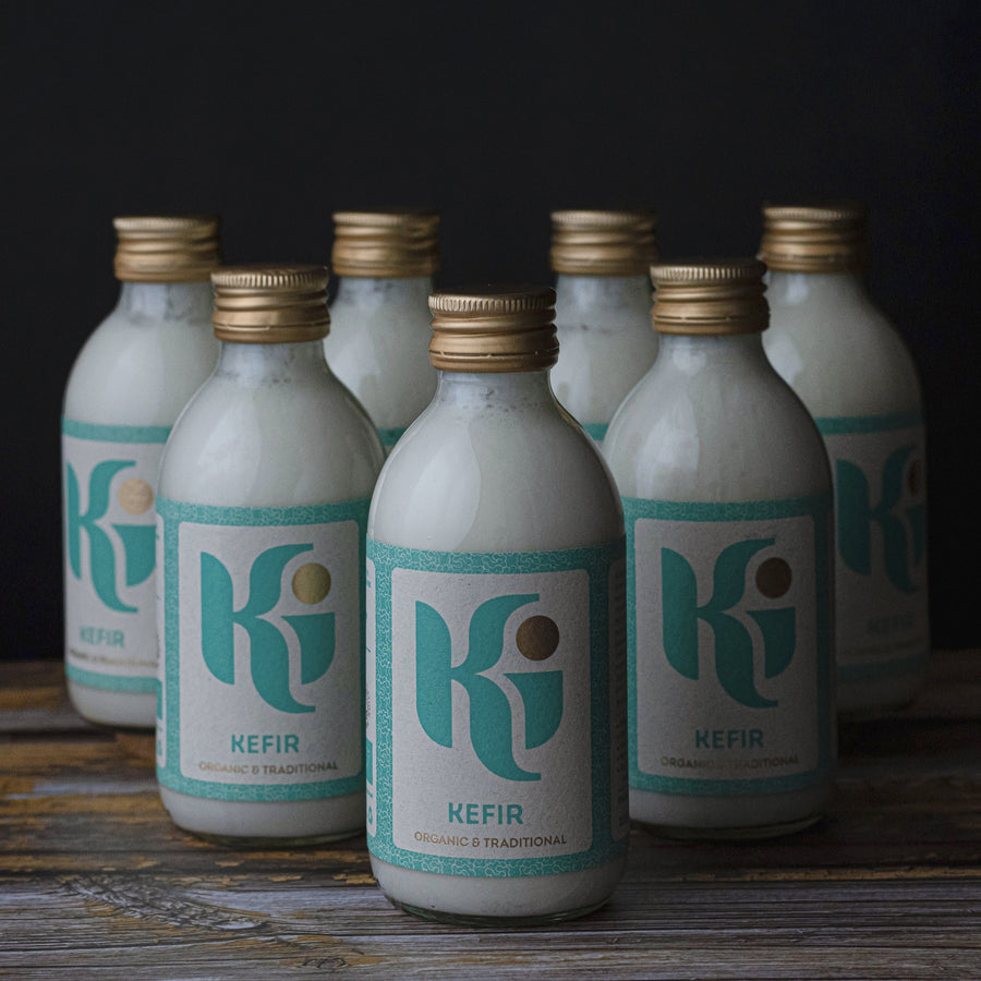 Lots of small glass bottles of 'Ki' kefir.