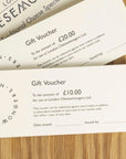 £10 and £20 gift vouchers for the London Cheesemongers shop, with envelopes on a wooden board.