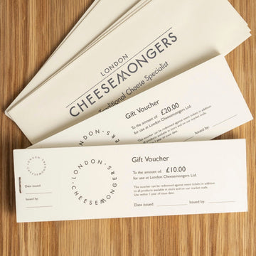 £10 and £20 gift vouchers for the London Cheesemongers shop, with envelopes on a wooden board.