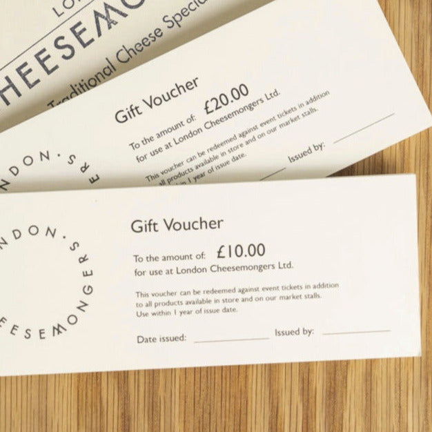 £10 and £20 gift vouchers for the London Cheesemongers shop, with envelopes on a wooden board.