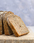 Slices of rye bread arranged on a wooden board.