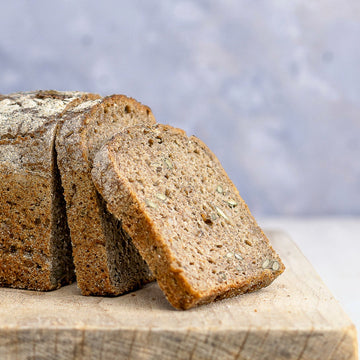 Slices of rye bread arranged on a wooden board.