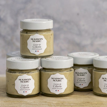 Jars of maison marc tapenade of celeriac on a wooden board.