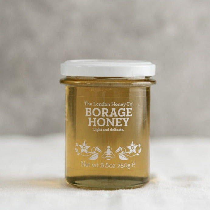 A clear glass jar of London Honey Co. 'Borage' honey.