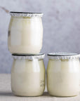 Small glass jars of organic French natural yoghurt.