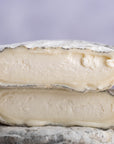 A close up photo of a two cut pieces of selles sur couffy goat's cheese.