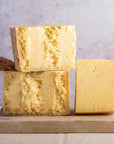 Pieces of Lancashire cheese on a wooden board.
