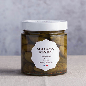 A jar of maison marc cornichons fins.