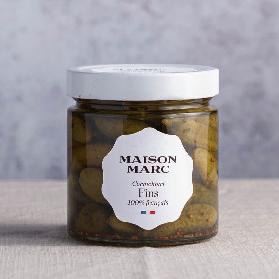 A jar of maison marc cornichons fins.