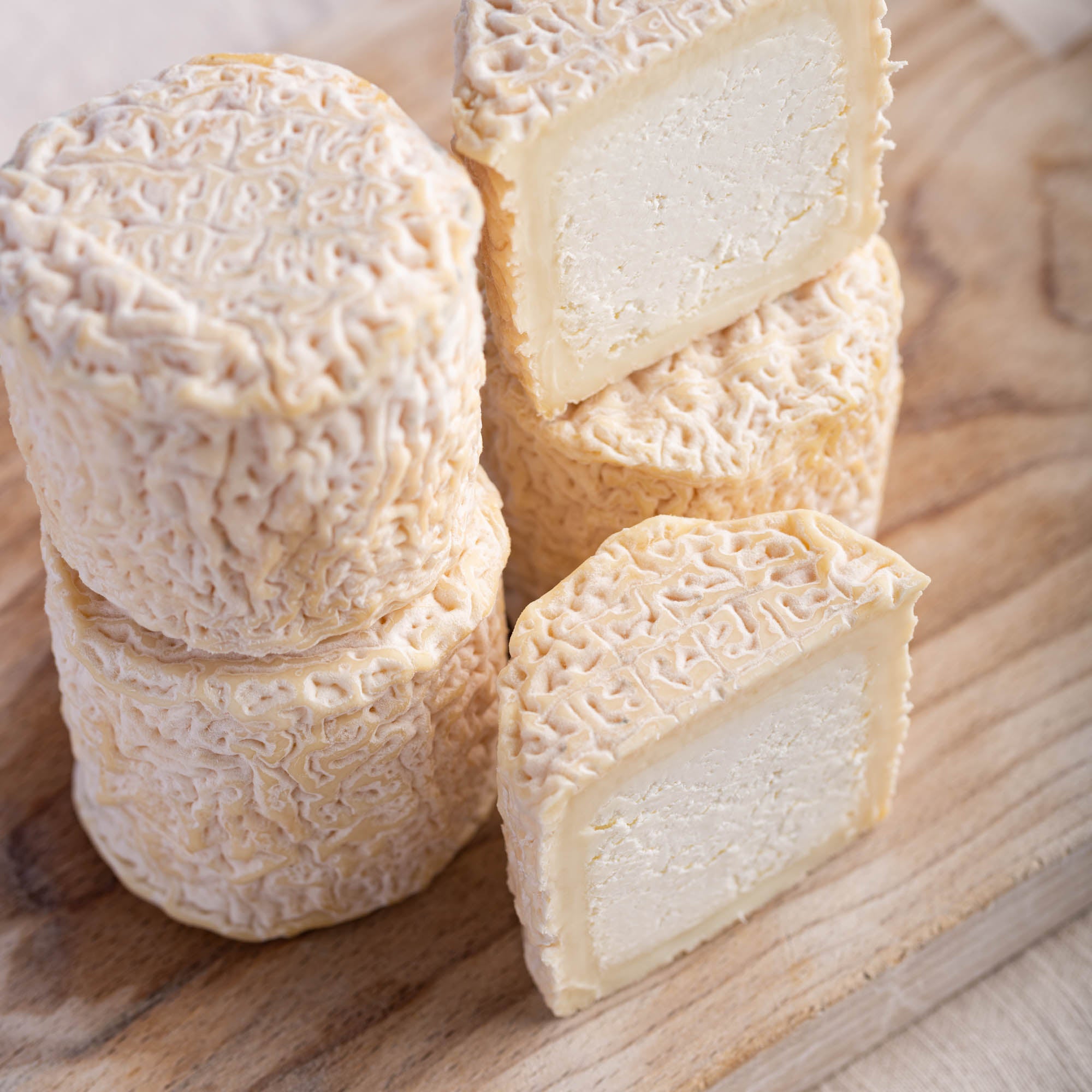 Close up of Petit Blaja french goat's cheese on a wooden board.
