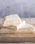 Cuts of Reblochon cheese on a wooden board.