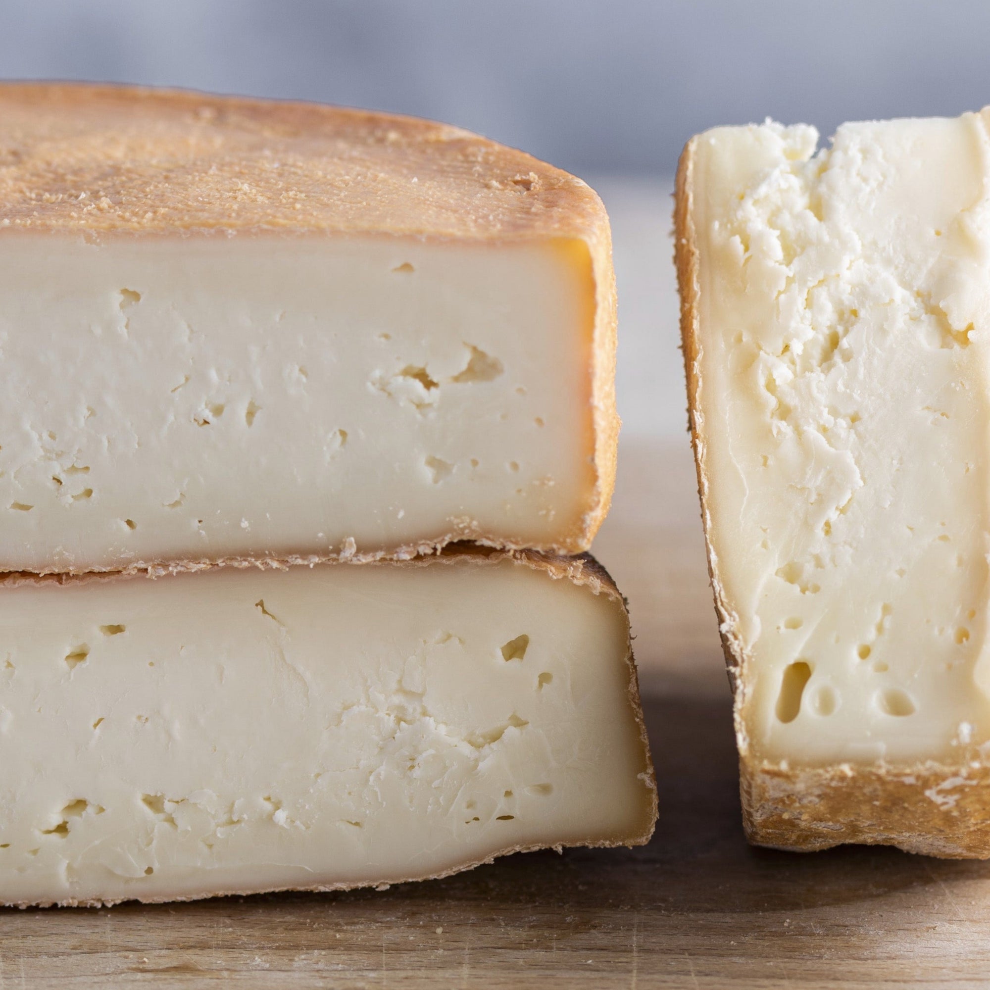 Cuts of Riseley cheese on a wooden board.