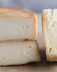 Cuts of Riseley cheese on a wooden board.