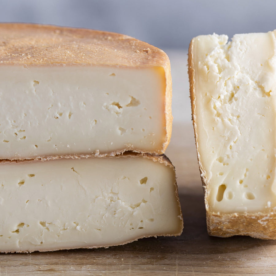 Cuts of Riseley cheese on a wooden board.