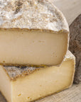 Cut pieces of French Tomme de Savoie hard cow's milk cheese.