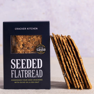 A packet of Cracker Kitchen seeded flatbread savoury biscuits.