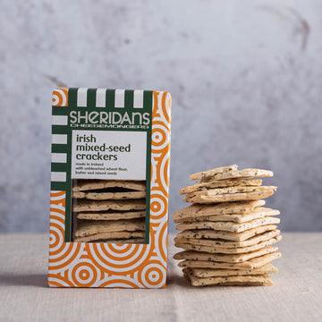 A stack of sheridans mixed seed crackers and their box.