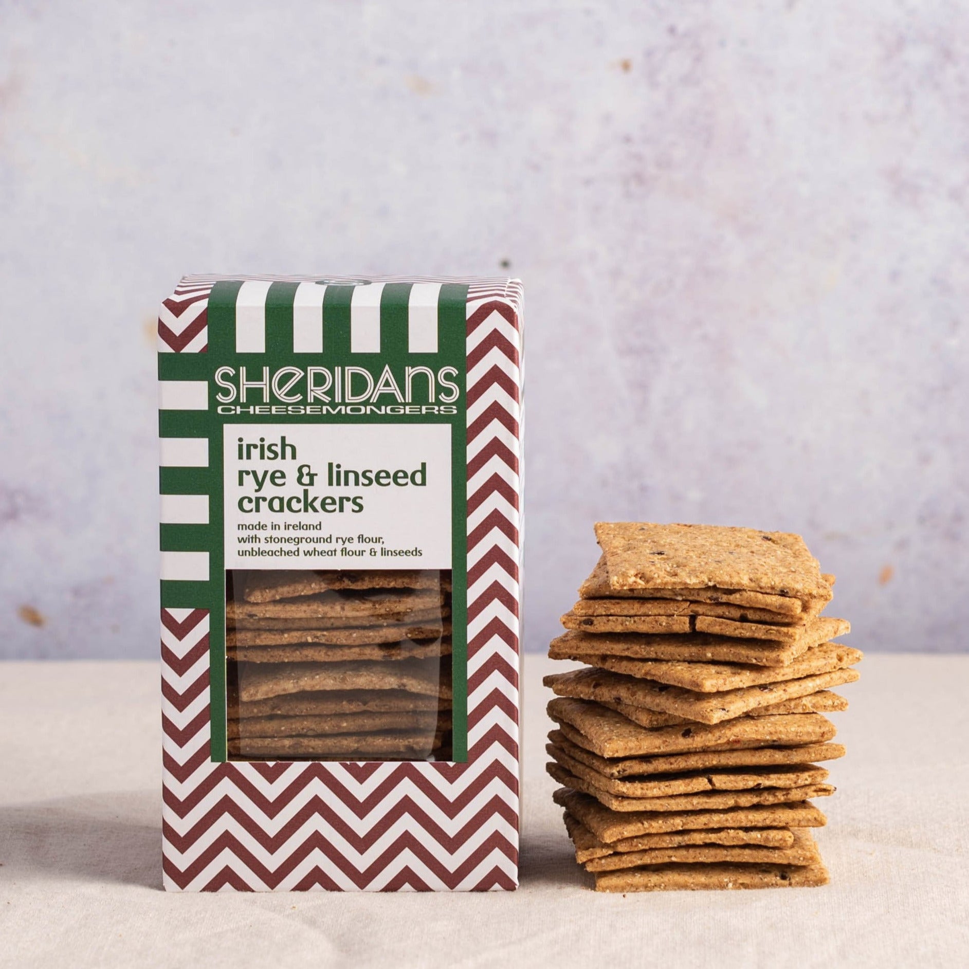 A stack of sheridans rye and linseed crackers and their box.