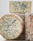 Whole and large cuts of Stilton blue cheese.